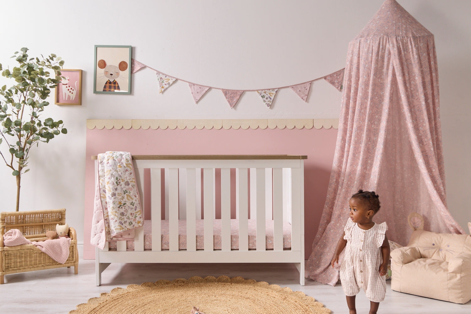 Nursery room with a Verona cot bed in white, pink canopy, and decorative elements from the Tiny Tails collection.