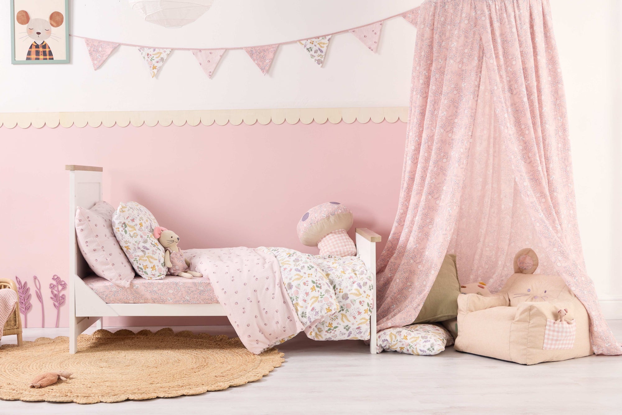 Children's bedroom with pink walls, a bed, and decorative elements from the Tiny Tails collection.