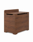 An angle view of the Origin toy box in walnut designed with rounded edges and a gap-front opening to minimize pinch points and maximize child safety.