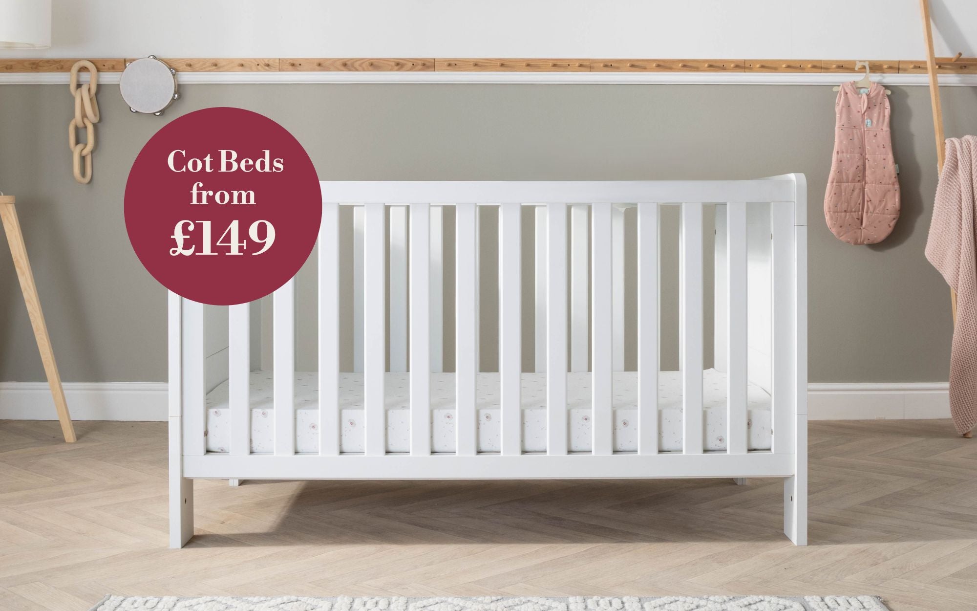 Alba white cot in a room with a price tag label on a red circle.