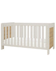 Front view of the Alba cot bed in white sand and distressed oak in a white background.
