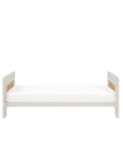 Front view of the Alba cot bed in white sand and distressed oak in the toddler bed mode in a white background.