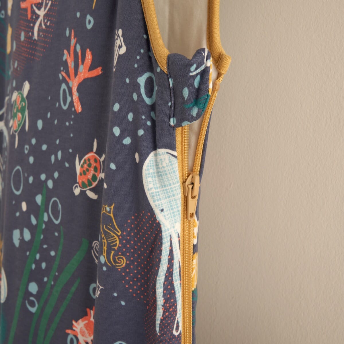Close-up of the Our Planet baby sleep bag’s zip feature and safety tab, designed for easy nighttime changes and secure comfort.