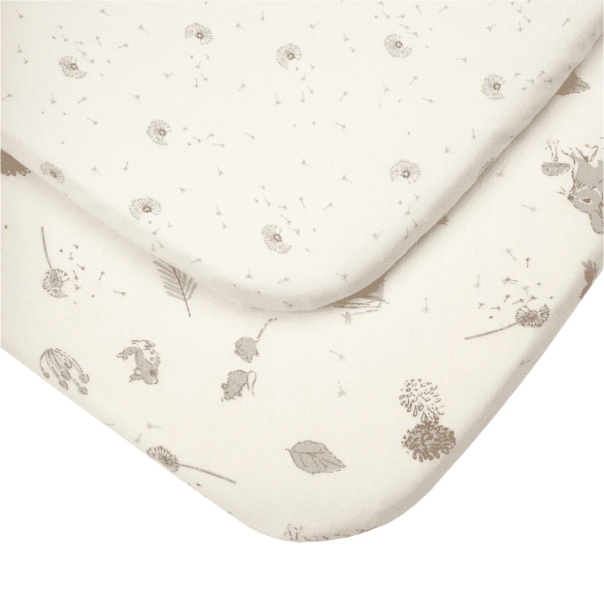 Detailed close-up of Cocoon bedside crib sheets, showing woodland animal and dandelion prints on soft organic cotton
