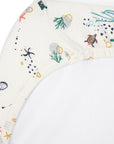 Close-up of Our Planet bedside crib fitted sheet in organic cotton, showing elasticated corner with playful sea life print detail