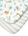Close-up of Run Wild bedside crib fitted sheets showing playful safari print with tigers and giraffes and stripped design