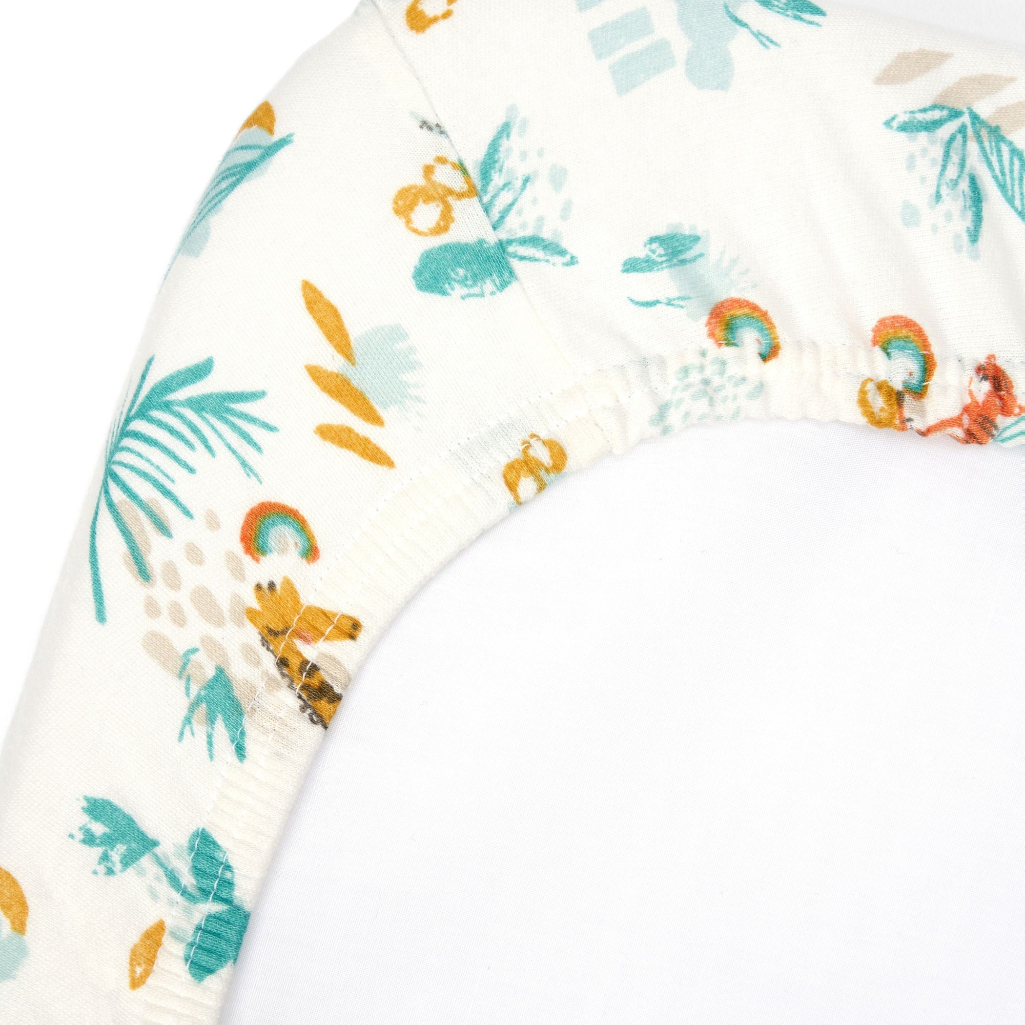 Corner close-up of Run Wild bedside crib sheet in organic cotton, showing elasticated edge and vibrant safari animal print detail