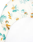 Corner close-up of Run Wild bedside crib sheet in organic cotton, showing elasticated edge and vibrant safari animal print detail