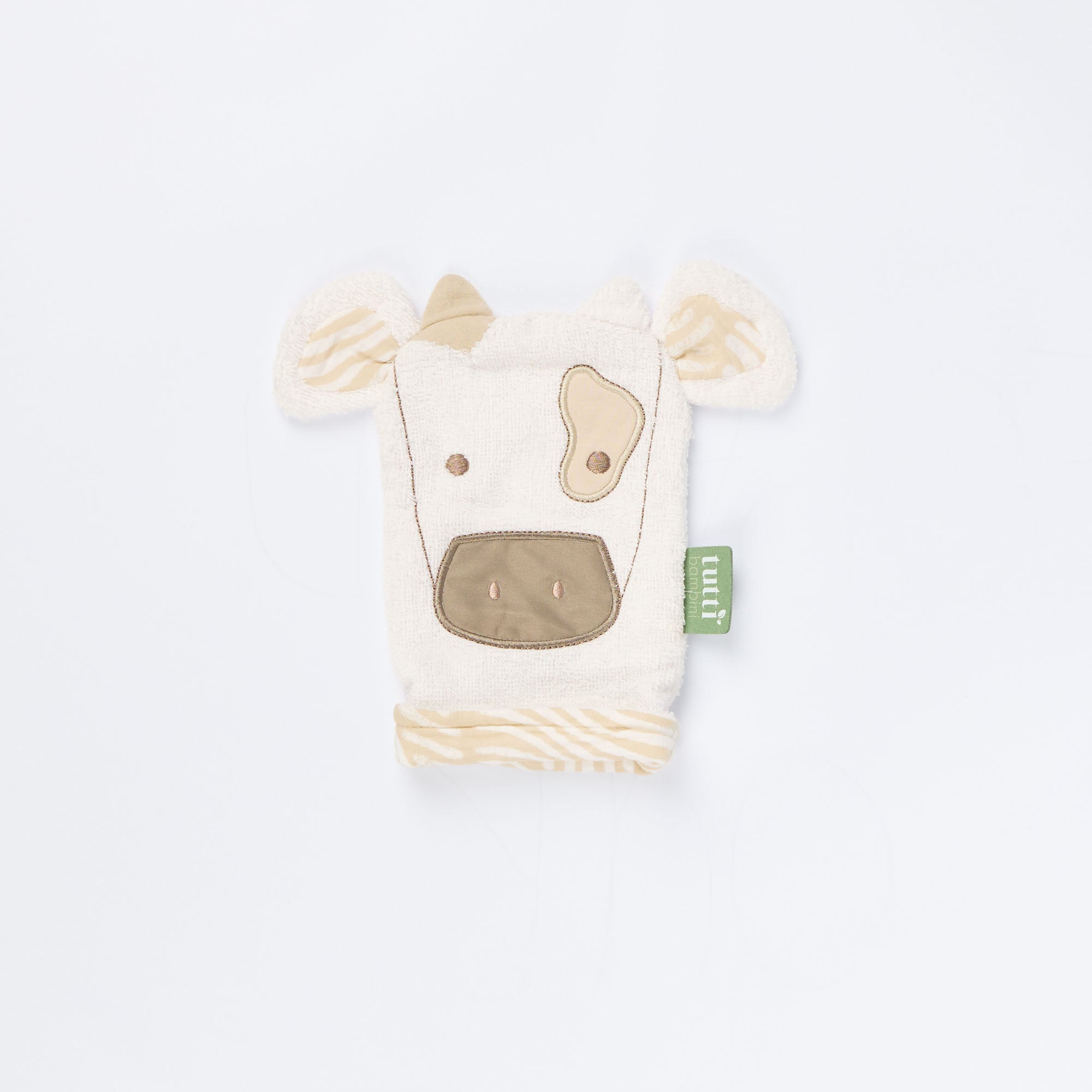 Close-up of Clemi the Cow wash mitt showing soft terry texture, beige embroidered cow face, and patterned inner fabric 