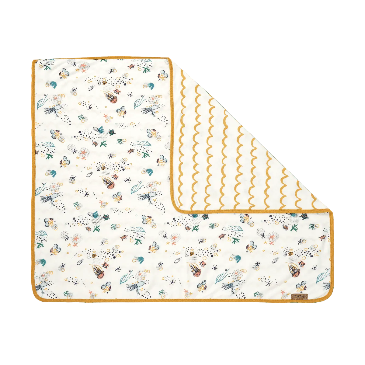 folded corner of a coverlet from the bedside crib bundle showing an aquatic themed design