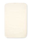 Cutout view of the CoZee bedside crib waterproof mattress protector in cream cotton, offering soft comfort and full protection