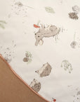 Fabric close-up of the Cocoon baby bean bag, showcasing the soft neutral upholstery and delicate woodland print top