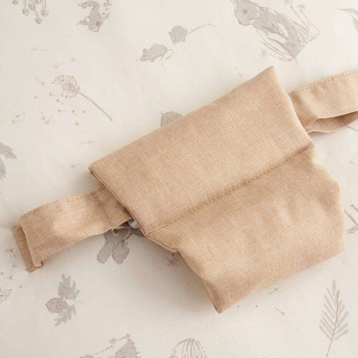 Detailed view of the Cocoon baby bean bag safety strap, highlighting secure fastening and soft fabric for gentle, supported lounging