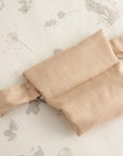 Detailed view of the Cocoon baby bean bag safety strap, highlighting secure fastening and soft fabric for gentle, supported lounging