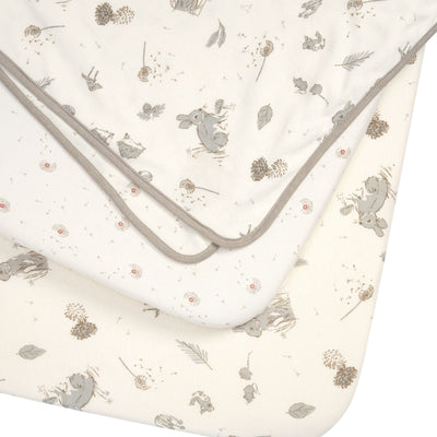 Cocoon bedside crib starter pack with two fitted sheets and a reversible coverlet, organic cotton in soft woodland animal designs