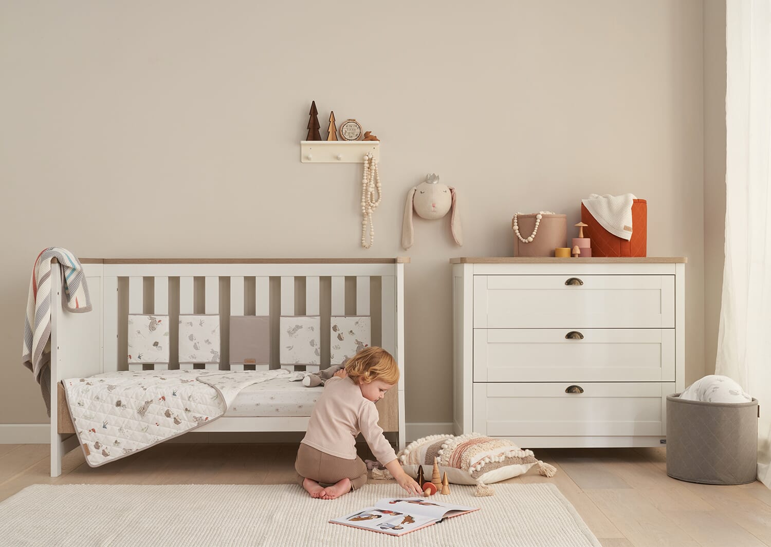 Calm nursery styled with the Cocoon collection, featuring neutral bedding, soft furnishings and soothing woodland-inspired details
