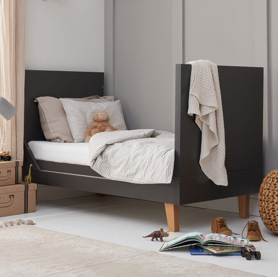 Como Cot Bed in toddler bed mode in a grey and modern nursery.