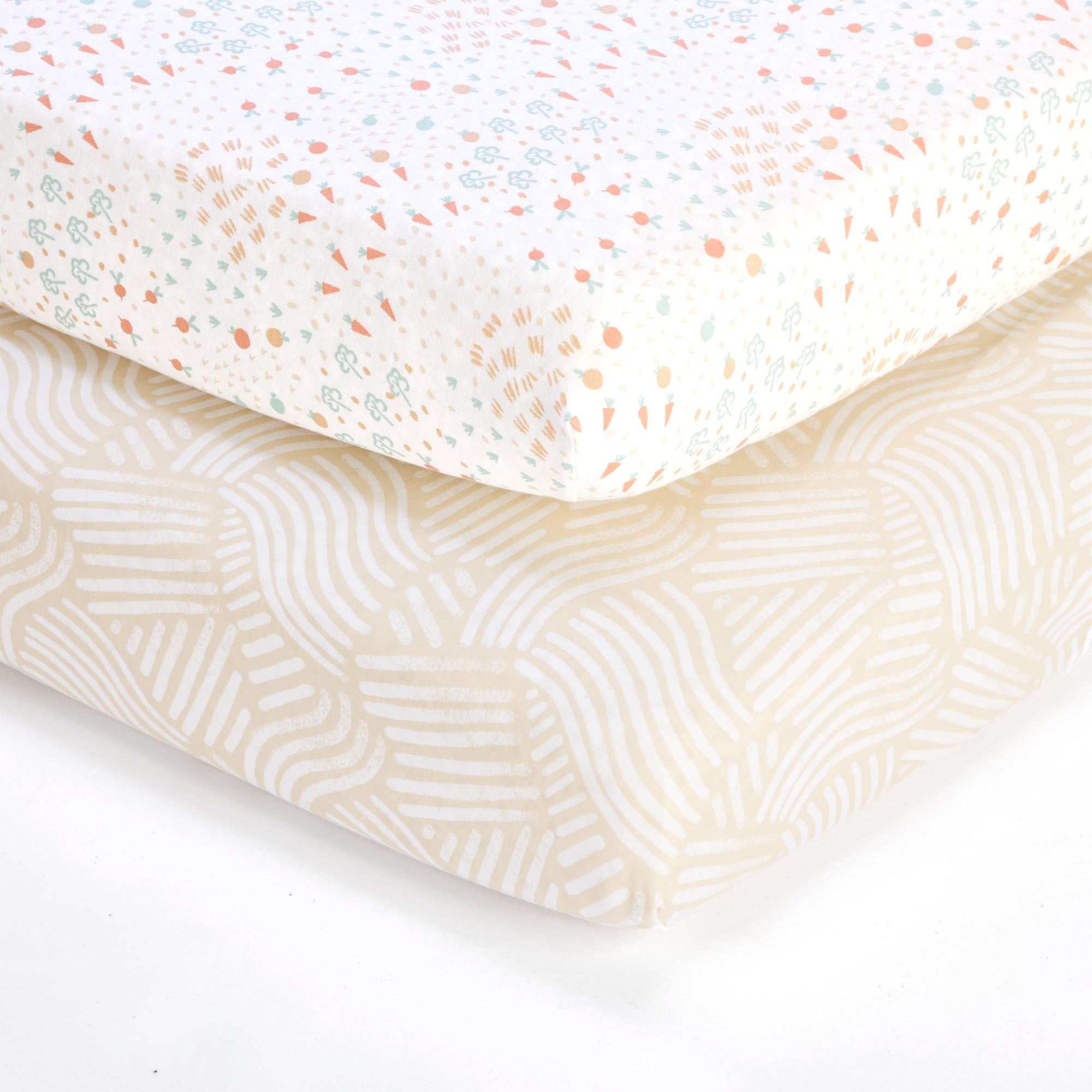 Close-up of cot bed fitted sheets in Good Life print, featuring soft neutral tones with playful carrot and abstract patterns.