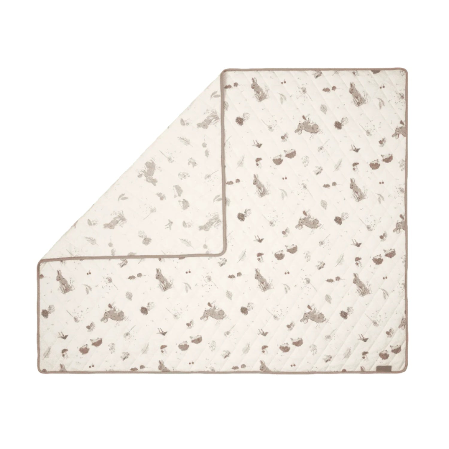 Cutout of Cocoon coverlet neatly folded, quilted soft cotton with woodland-themed prints offering lightweight comfort and design