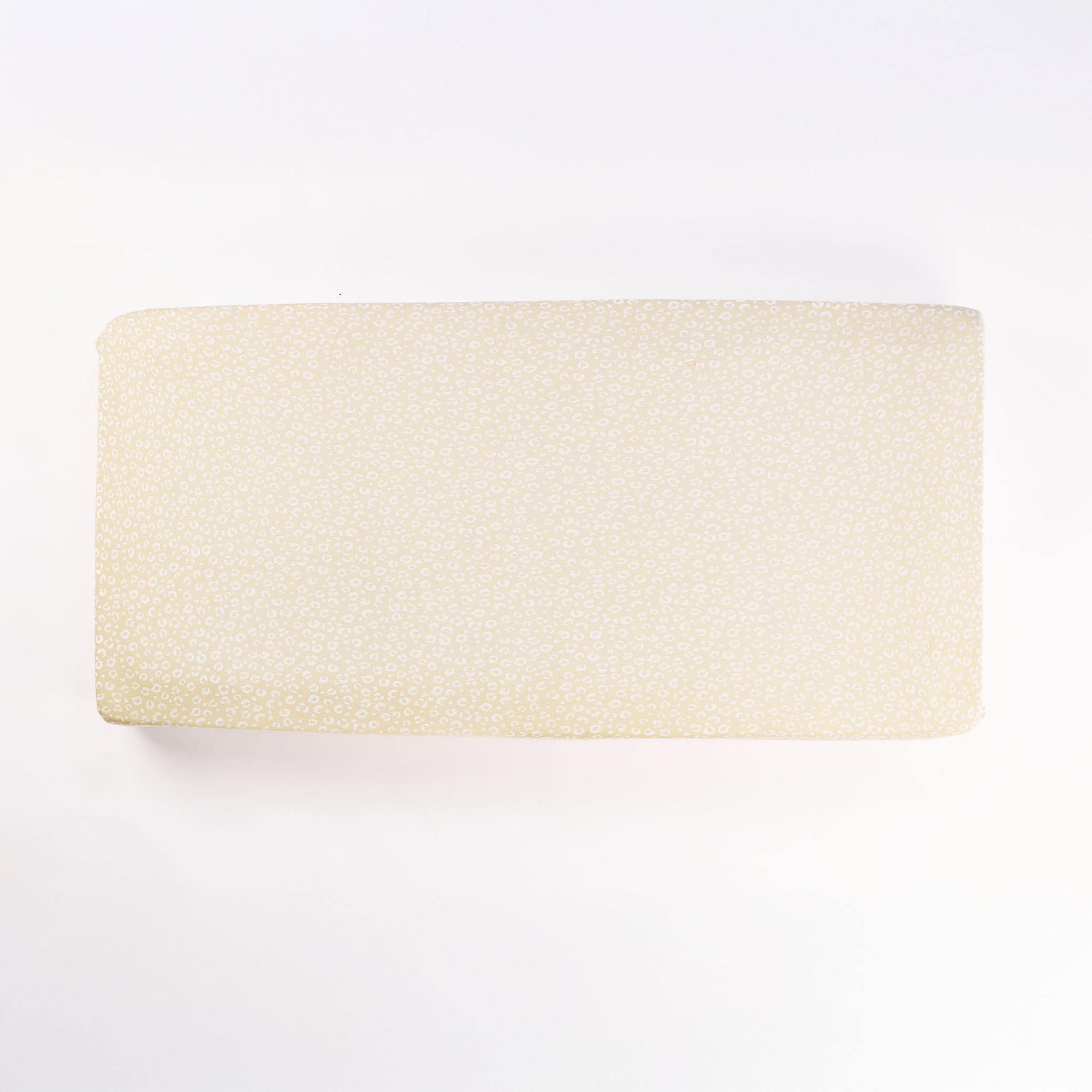 Cutout view of the Love Cats fitted sheet in beige with tonal leopard-inspired print, made from soft breathable bamboo jersey.