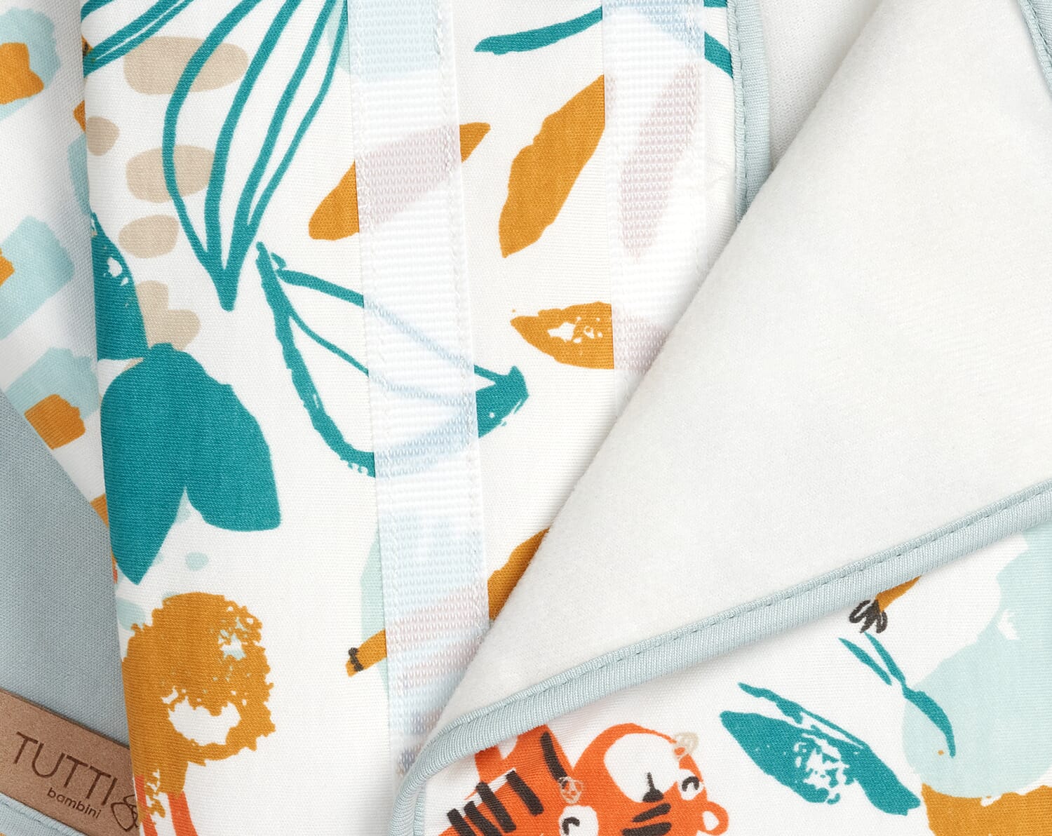 Close-up of Run Wild cot wrap velcro fastening, highlighting adjustable fit and softly padded design for secure cot rail coverage