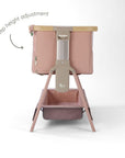CoZee Air 2 bedside crib in drifted oak and blush showing gentle tilt function designed to help ease reflux.