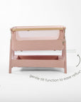 CoZee Air 2 bedside crib in toasted oak and sand featuring 6-step height adjustment for easy bedside positioning.