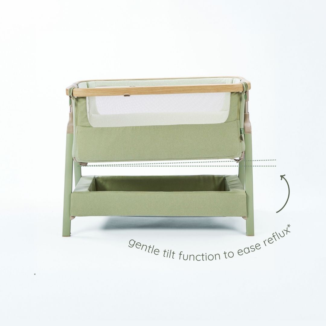 CoZee Air 2 bedside crib in drifted oak and blush with 6-step height adjustment and integrated lower storage shelf.