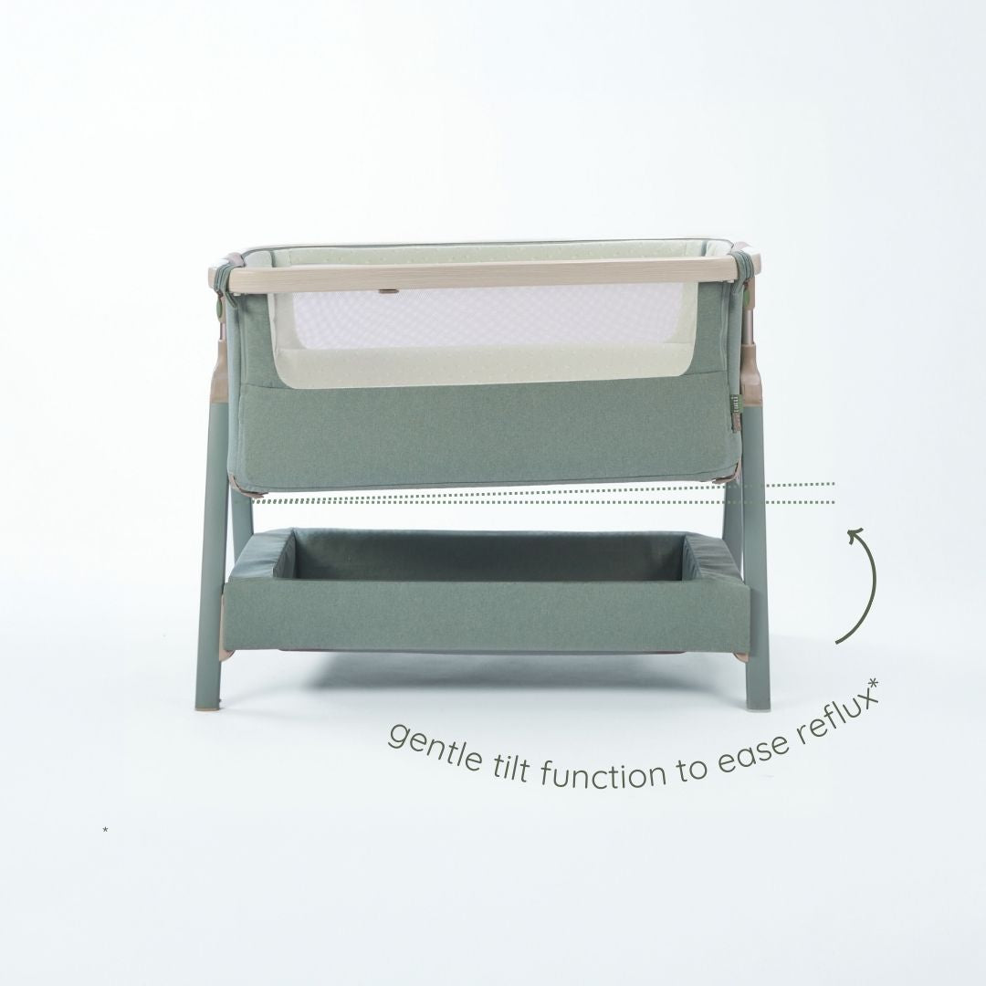 CoZee Air 2 bedside crib in whitewash and kelp demonstrating gentle tilt function to support reflux relief.