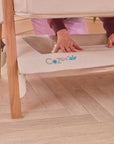 CoZee Air in Scandinavian and Ecru with under-crib storage basket – lifestyle image showing space for baby essentials