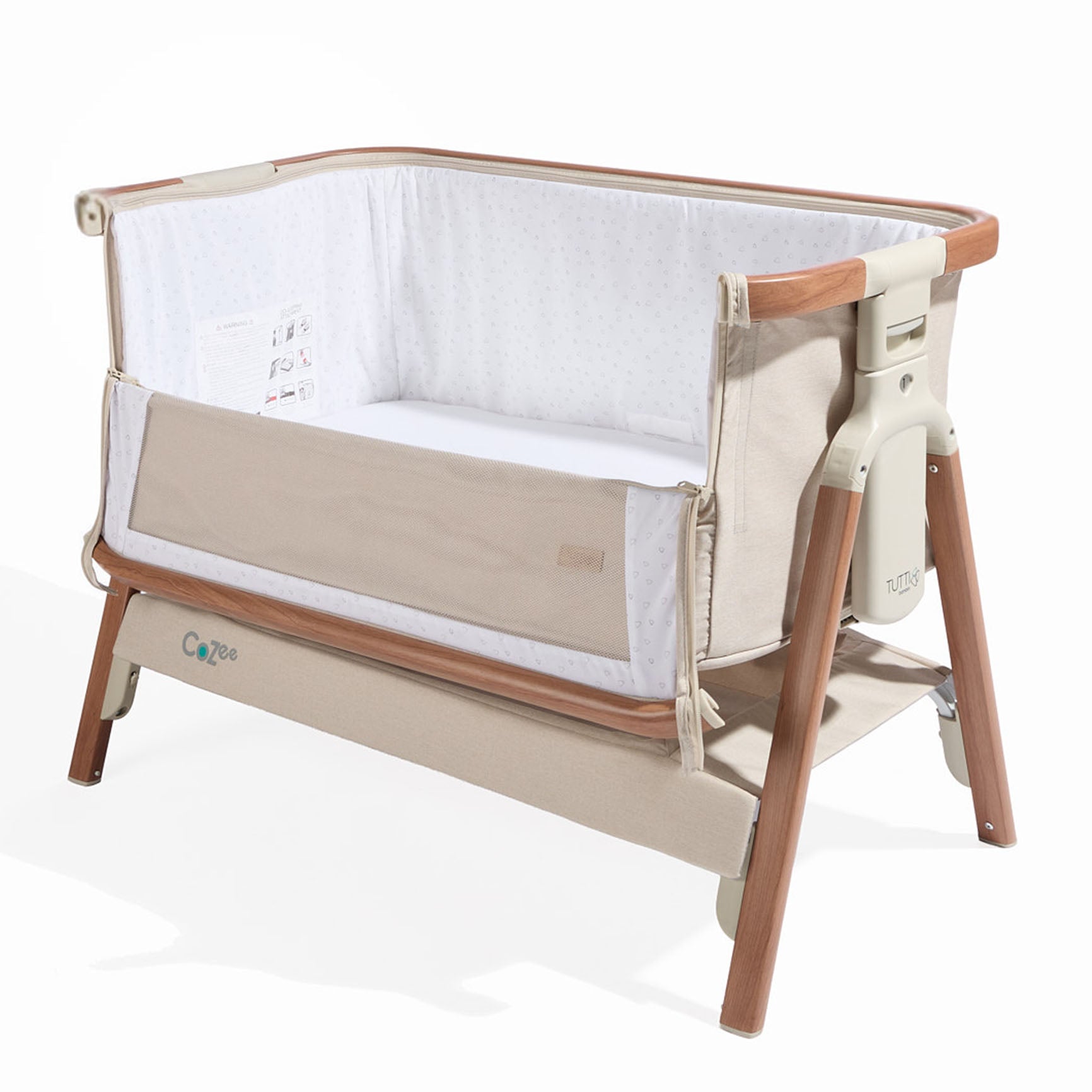 Cutout view of the CoZee bedside crib in Scandinavian walnut and ecru, showing unzipped breathable mesh side and under-crib storage shelf