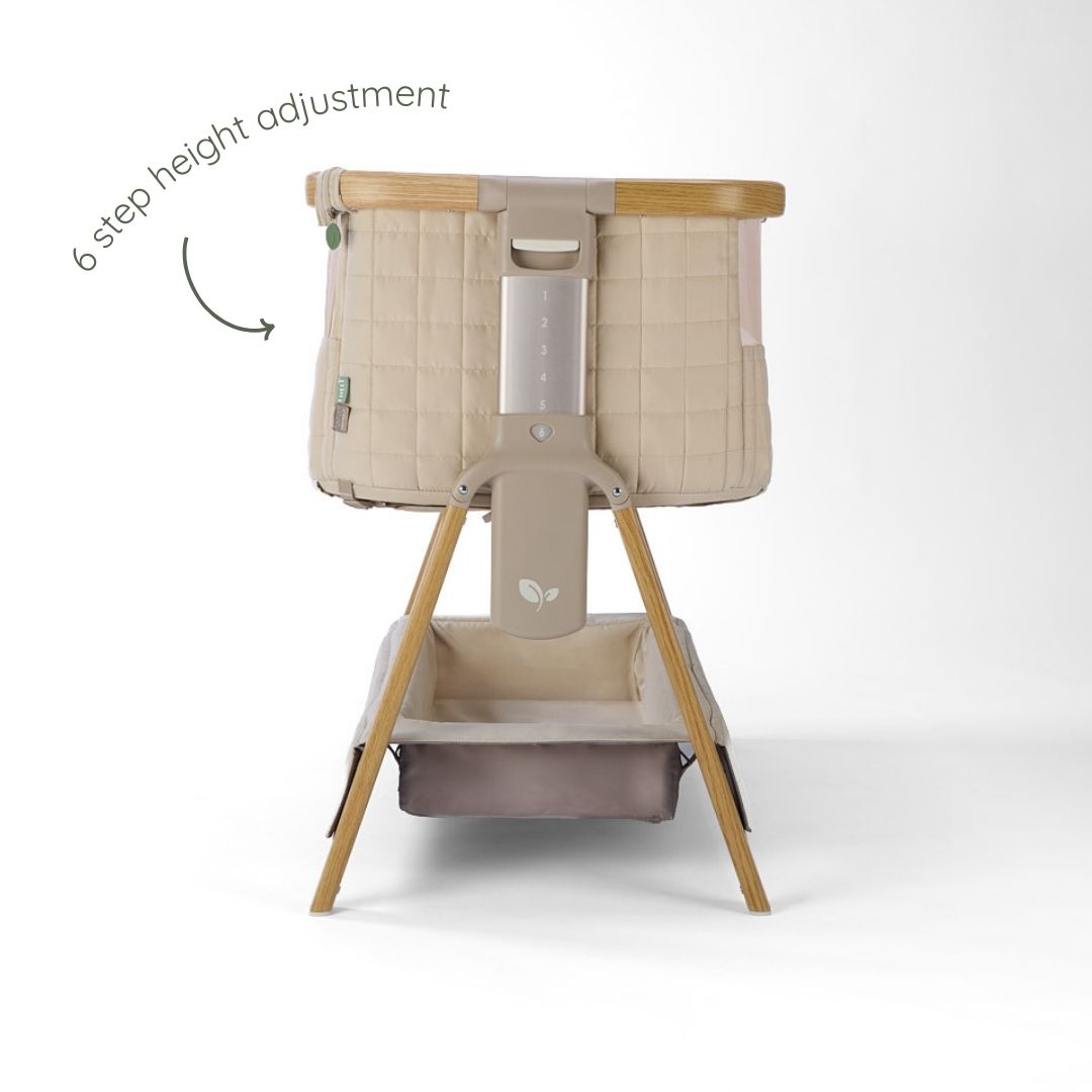 CoZee Sense bedside crib in toasted oak and sand featuring 6-step height adjustment and quilted fabric panels.