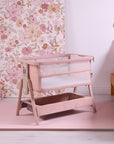 cozee zen blush shown at an angle in a well lit bedroom with pink floral tones