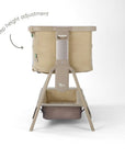 CoZee Zen bedside crib in sand finish showing 6-step height adjustment and integrated lower storage shelf.