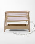 CoZee Zen bedside crib in sand demonstrating gentle incline setting designed to help ease reflux.