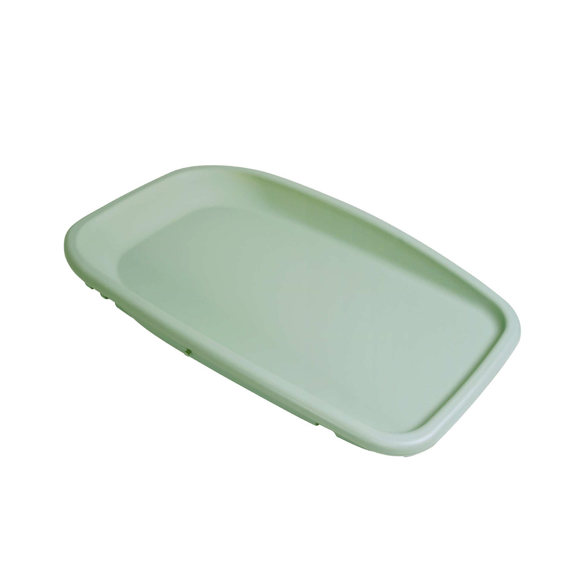 Angled cutout view of the Cushi changing mat in soft leaf green finish with raised sides for added safety and comfort