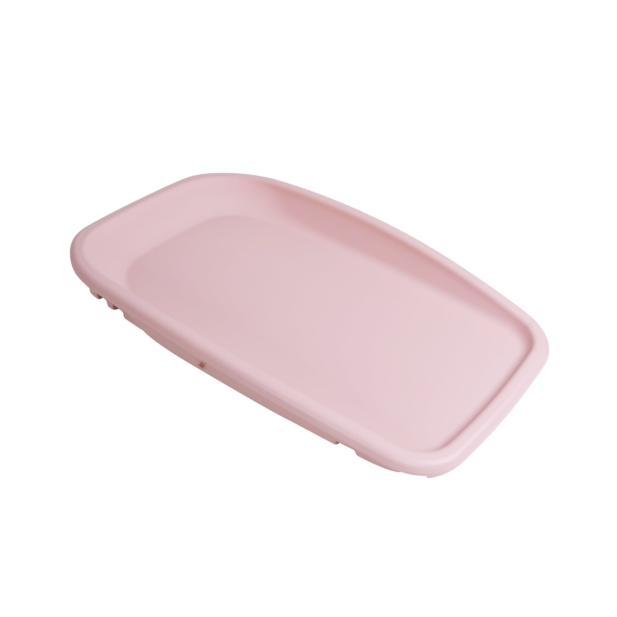 Angled cutout of the Cushi baby changing mat in petal pink, highlighting contoured shape, raised sides, and practical design
