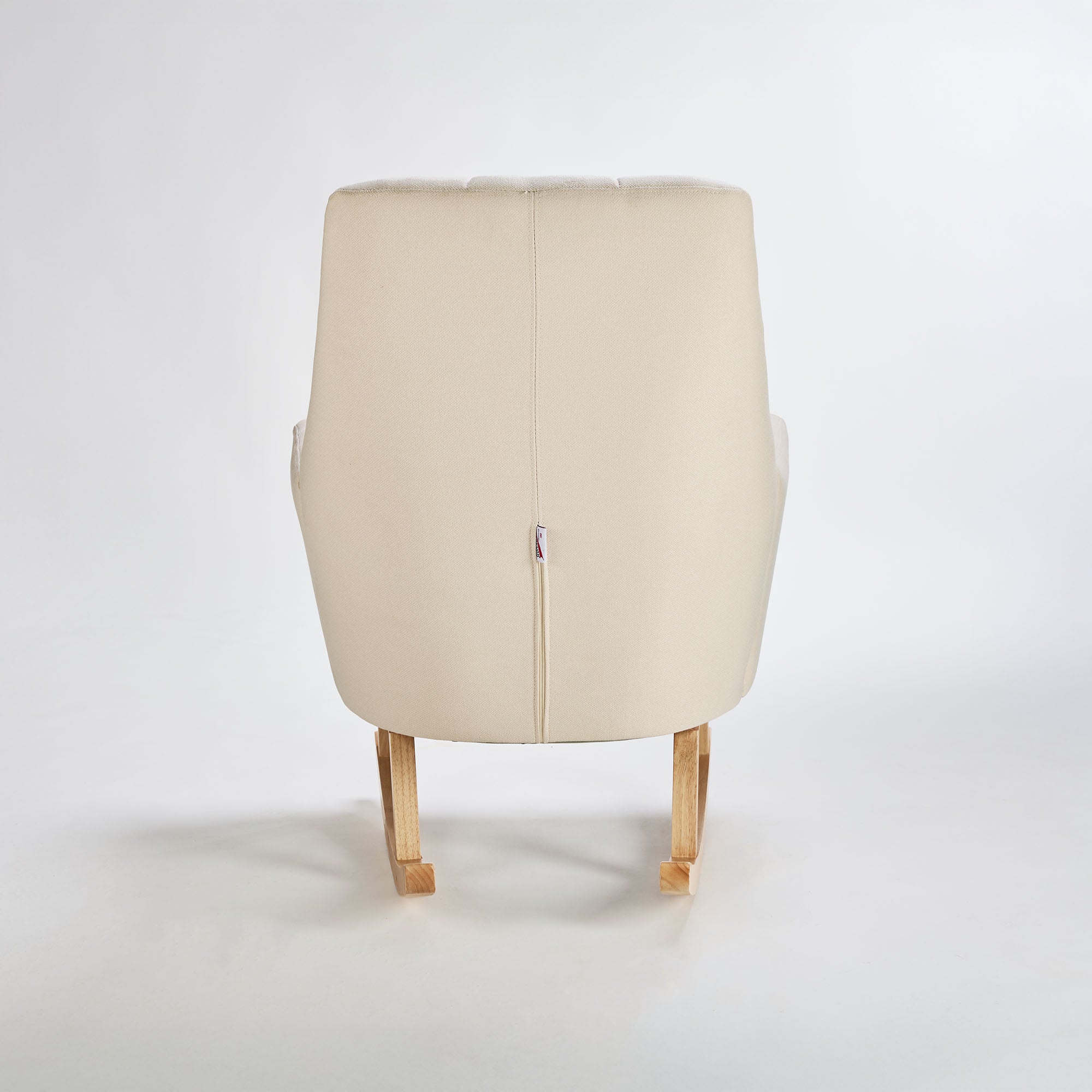 Back view of the Danica rocking chair in cashmere, showcasing smooth upholstery and light wood base for a calm, elegant finish