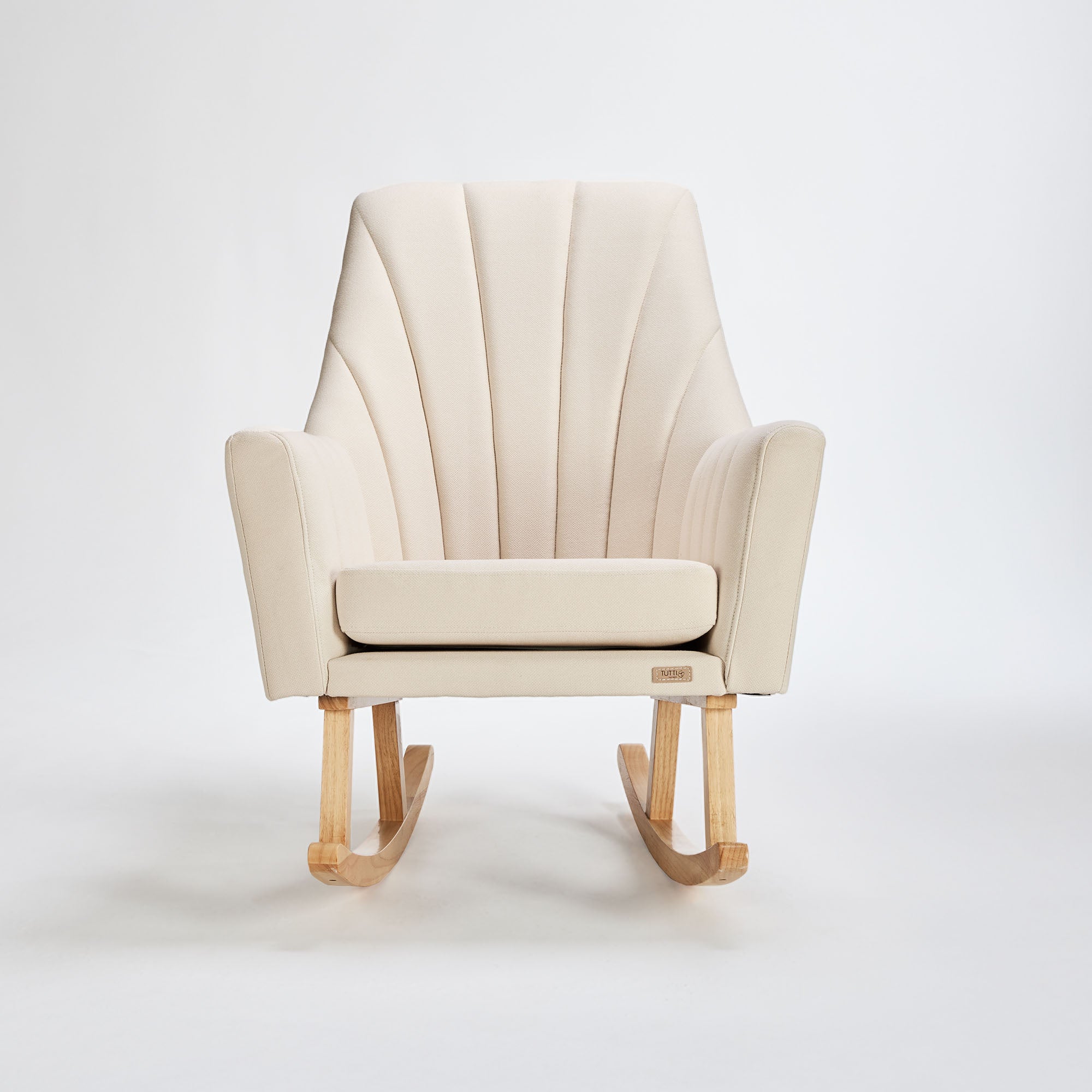 Front view of the Danica rocking chair and footstool in cashmere fabric with oak legs, blending soft curves and modern design