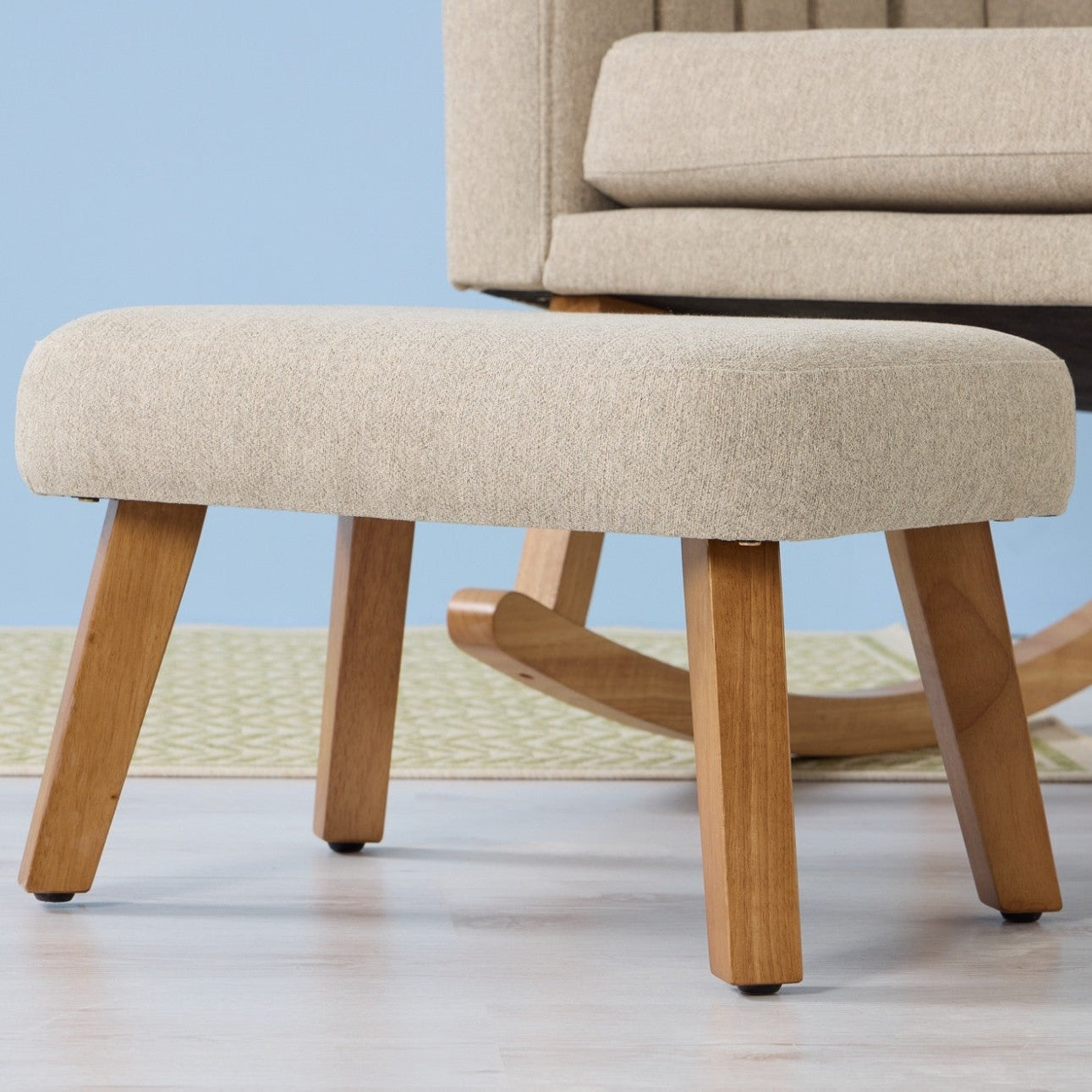 Danica rocking chair and footstool in stone showing stone fabric with oak legs, offering modern comfort 