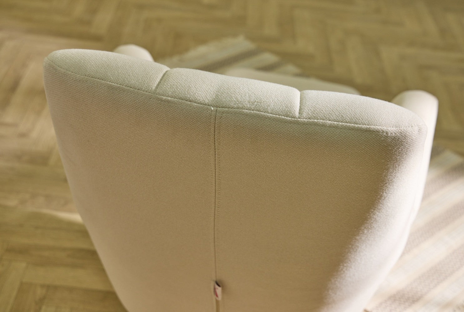 close up of danica rocking chair featuring padded backrest for added comfort and posture support