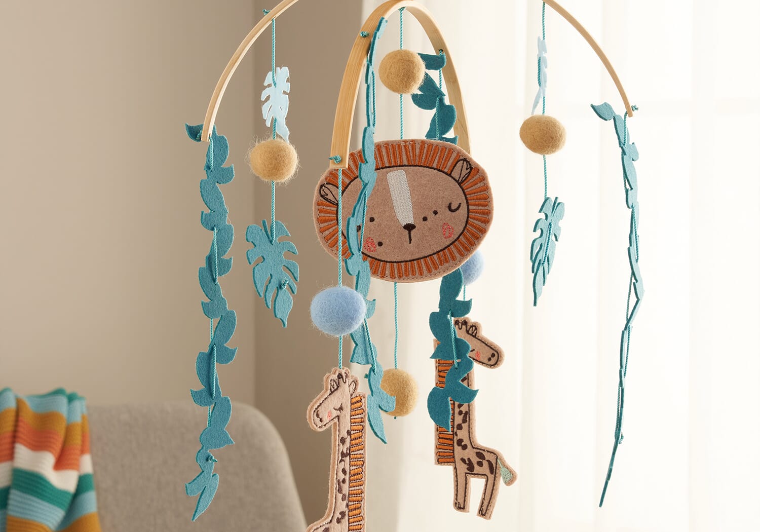 Run Wild felt nursery mobile hanging in a nursery setting, combining safari animals, soft felt textures and gentle movement for visual interest