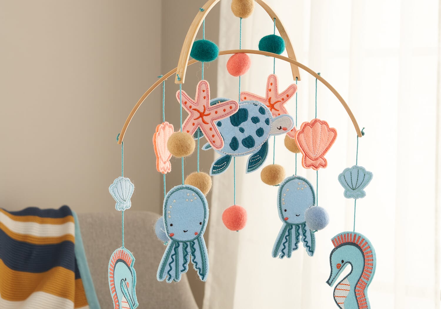 Our Planet felt nursery mobile featuring sea creatures and soft felt textures to create a calming, ocean-inspired space