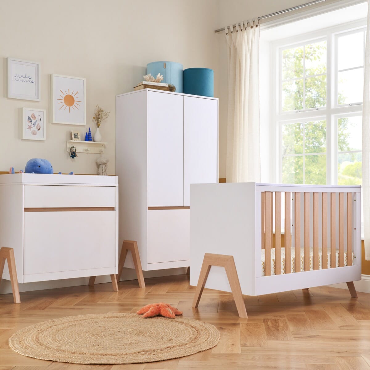 Fuori mini 3-piece nursery furniture set in white and light oak, including cot bed, chest changer and wardrobe in a coordinated room setting