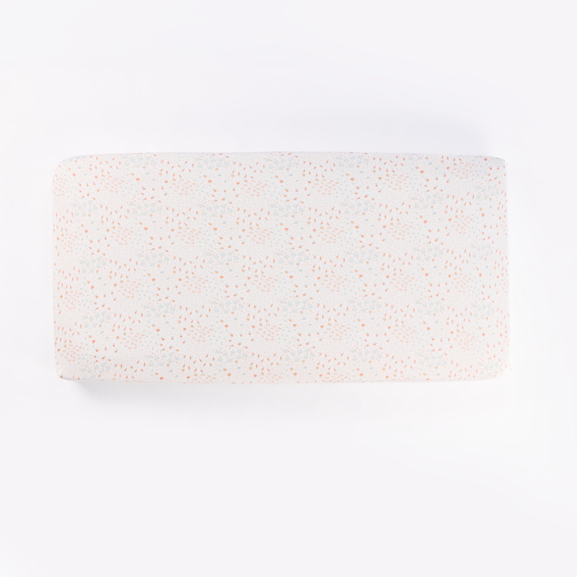 Cutout of Good Life cot fitted sheet in cream with soft scattered print of pastel florals and abstract dots, made from breathable cotton
