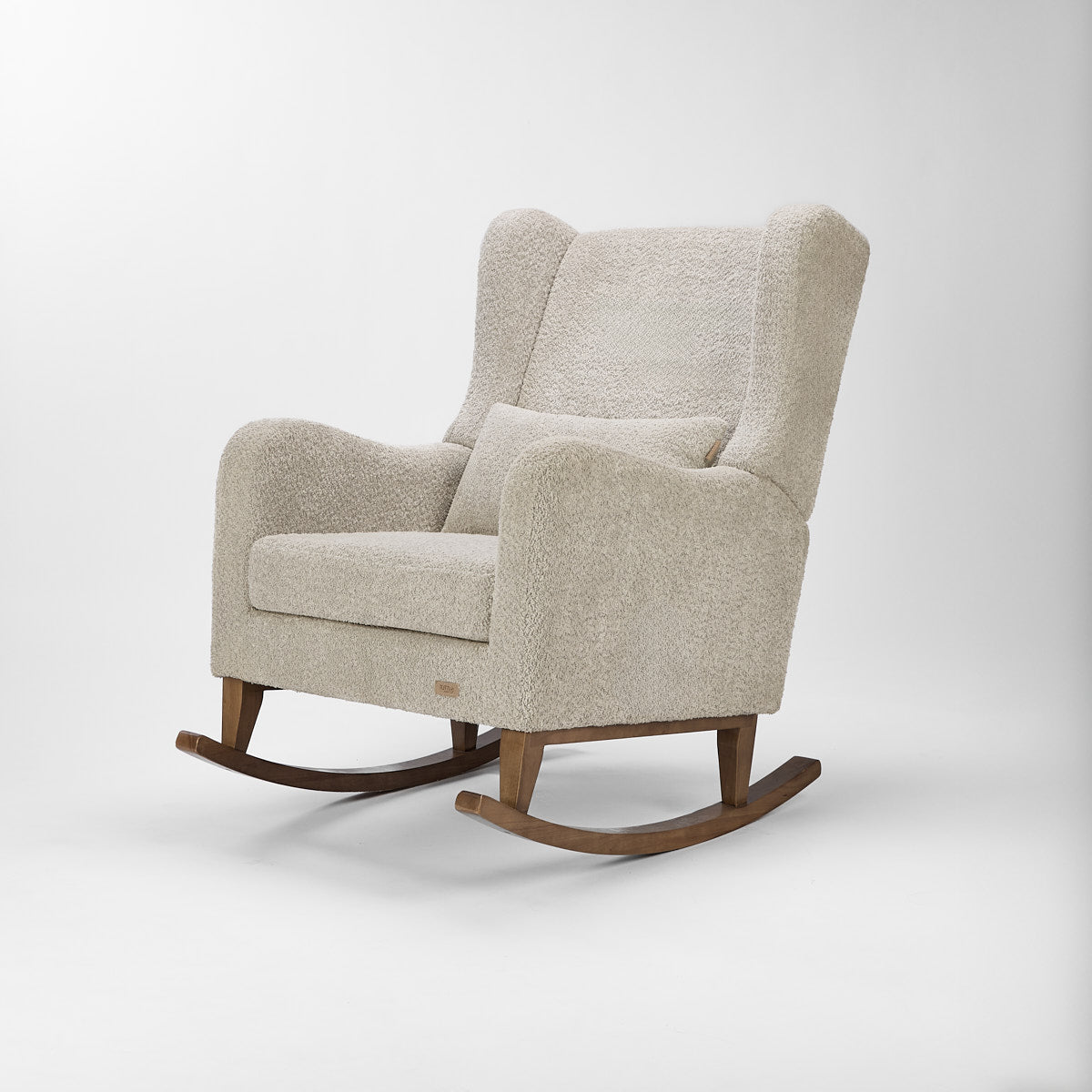 Angled cutout of the Harper Wingback rocking chair in teddy mushroom finish, showing plush wingback design and oak rocking base.