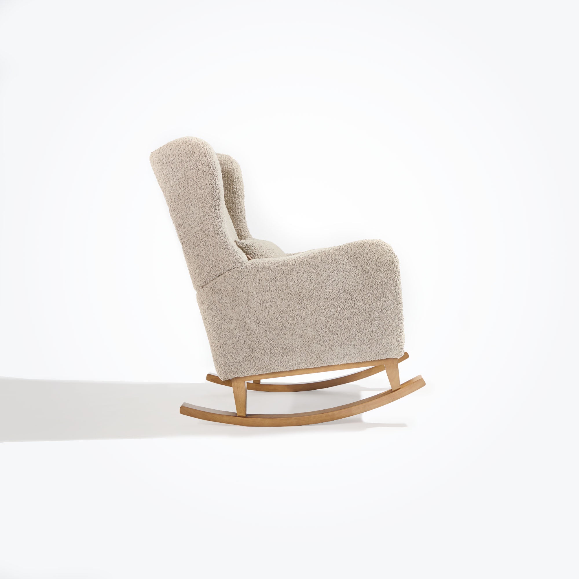 Side cutout of the Harper Wingback rocking chair in teddy mushroom, featuring smooth rocking motion and generous armrest profile.