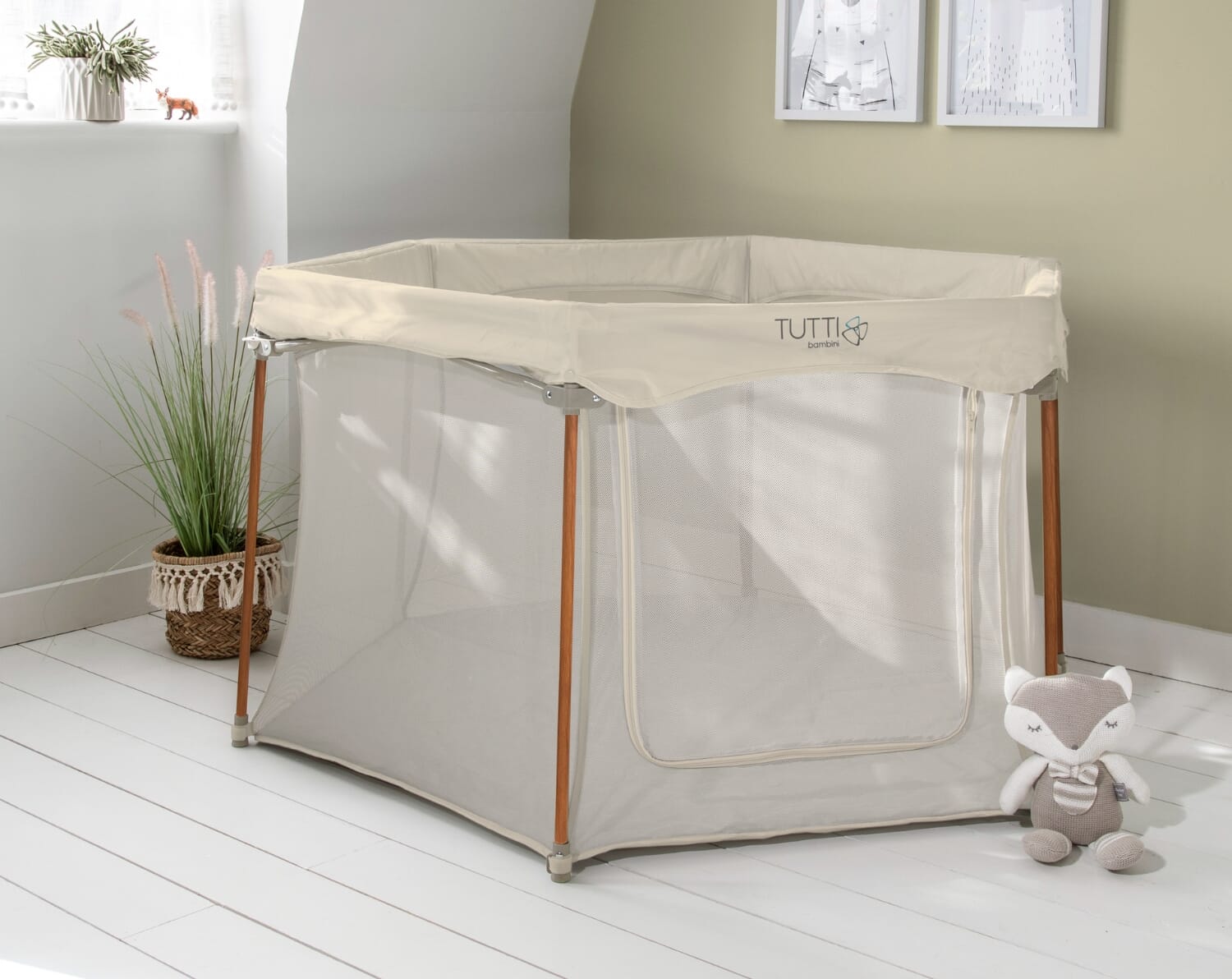 Hexa playpen in ecru finish styled in a light-filled room, featuring breathable mesh sides and a soft, neutral design for everyday play