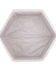 Overhead view of the Hexa playpen in grey, showing its padded hexagonal base and soft, enclosed sides for secure play