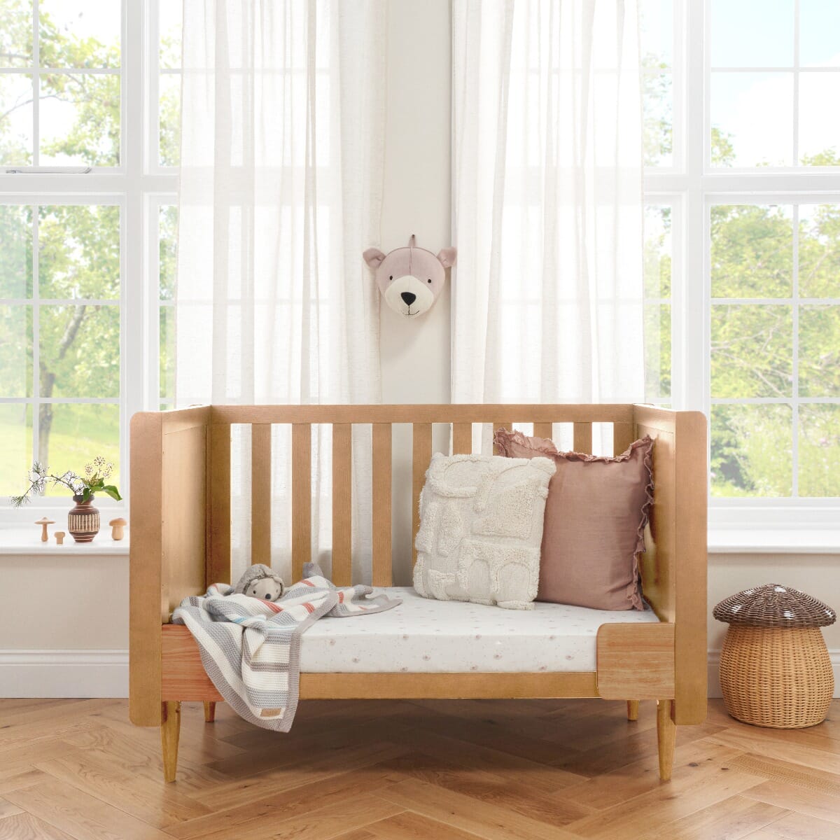 Japandi Mini Cot Bed in light oak shown in sofa mode with cushions, ideal for toddlers and versatile for daytime lounging